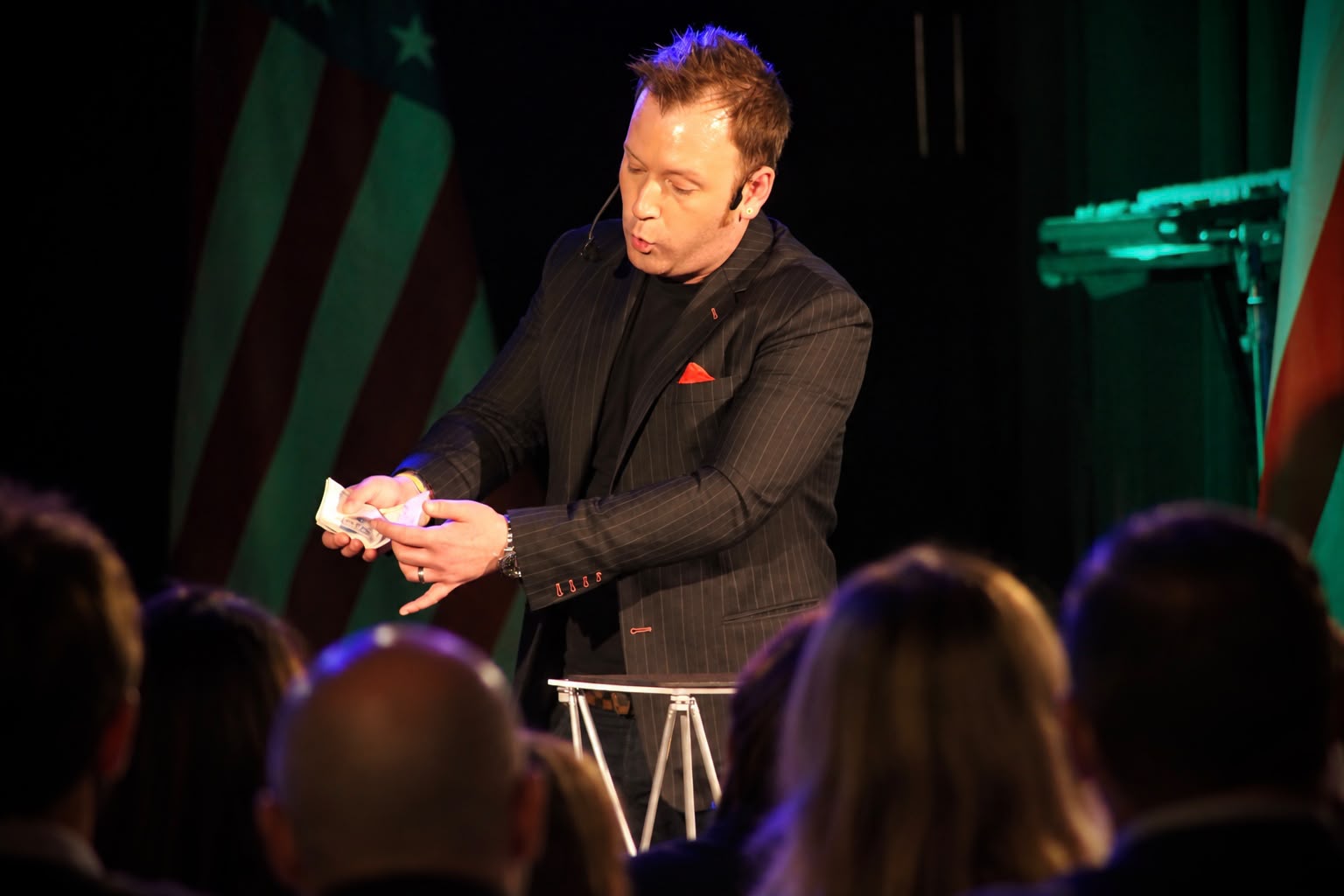 Steve Dela performing a cabaret mentalism show on stage